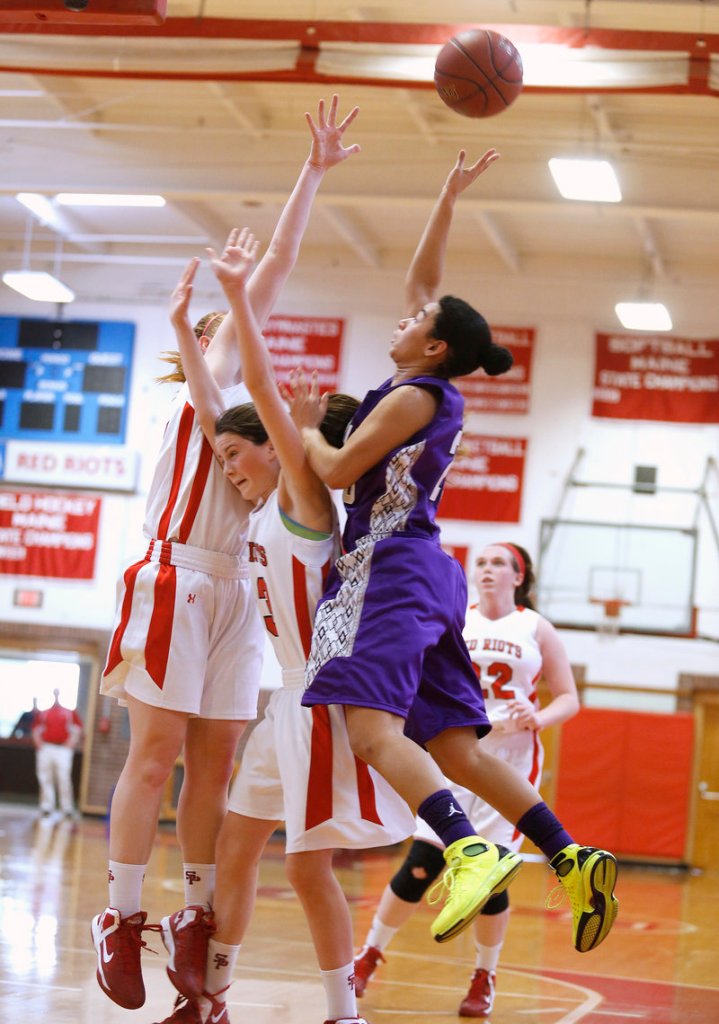 Keneisha DiRamio, who scored a game-high 14 points for Deering, shoots over Maddie Hasson, center, and Brianne Maloney of South Portland.