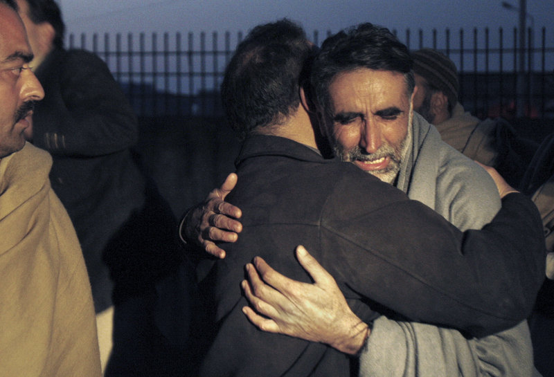 A father of an aid worker who was killed by gunmen mourns the death of his daughter at a hospital in Swabi, Pakistan, Tuesday. Gunmen in northwest Pakistan killed at least five female teachers and two aid workers in an ambush on a van carrying workers home from their jobs at a community center, officials said.