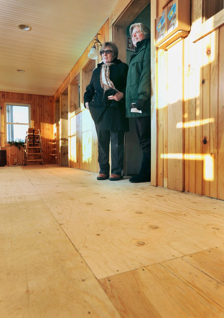 Joan Mercier, owner of the Freeport Cafe, is one of numerous customers jilted by a flooring store that went out of business. Mercier, left, and her assistant manager, Pam Bird, stand in the doorway of a recently built addition to the restaurant, which is currently without carpet.