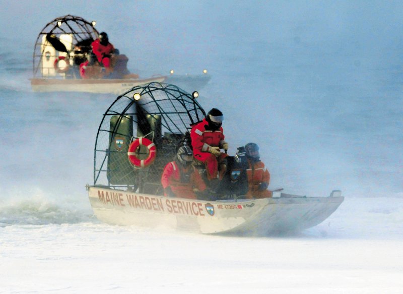 A warden service airboat, in front, slides back onto ice as a second boat motors in open water on Rangeley Lake on Thursday.