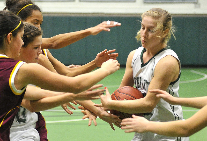 Waynflete’s Martha Veroneau tries to keep the ball away from several outstretched arms.