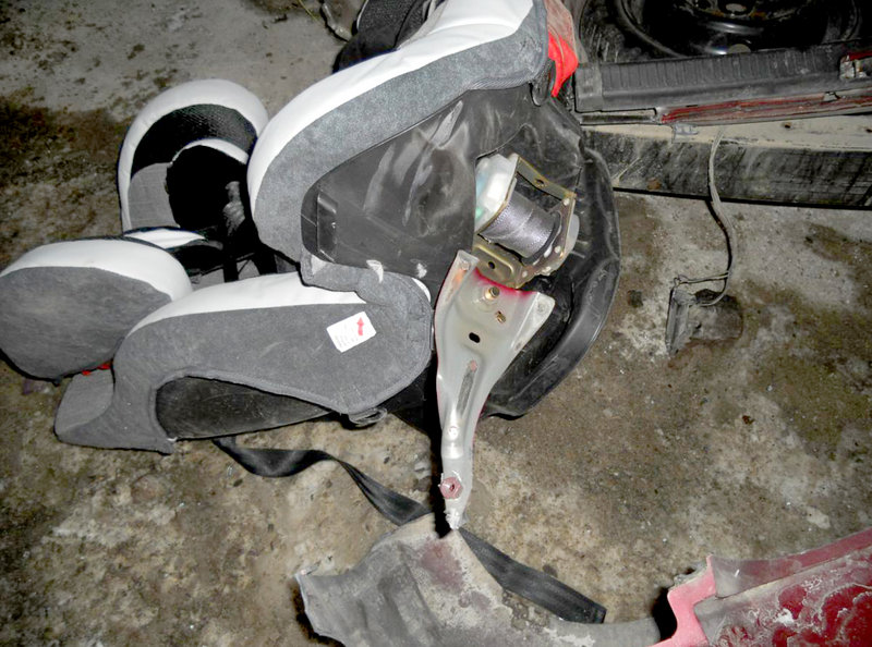 The infant car seat in use at the time of a collision in Raymond on Thursday shows how it was still attached to the car's seat belt mechanism after the impact and after a 6-month-old child was thrown from the car and from the seat itself.