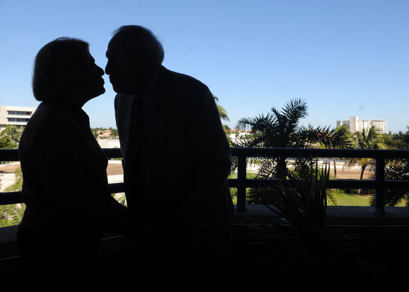 Zelda Luxenberg, left, and Robert Levinson share a kiss on the balcony of Robert’s condo in Delray Beach, Fla. The two paid $1,000 to see their love story in print.