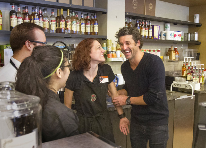 Maine native and “Grey’s Anatomy” star Patrick Dempsey, right, meets the staff at the Tully’s Coffee near the Pike Place Market in Seattle on Friday. His Global Baristas company won a bankruptcy auction to purchase the chain.
