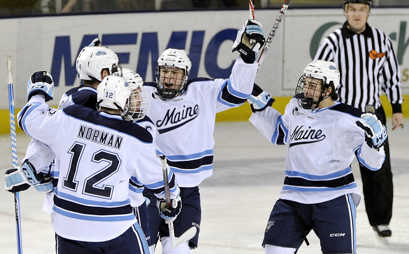 Maine players celebrate their first goal of the game, a first-period tally by Joey Diamond that tied the score at 1-1. A power-play goal by Maine’s Ryan Lomberg with about six minutes remaining sealed the win on Friday night.