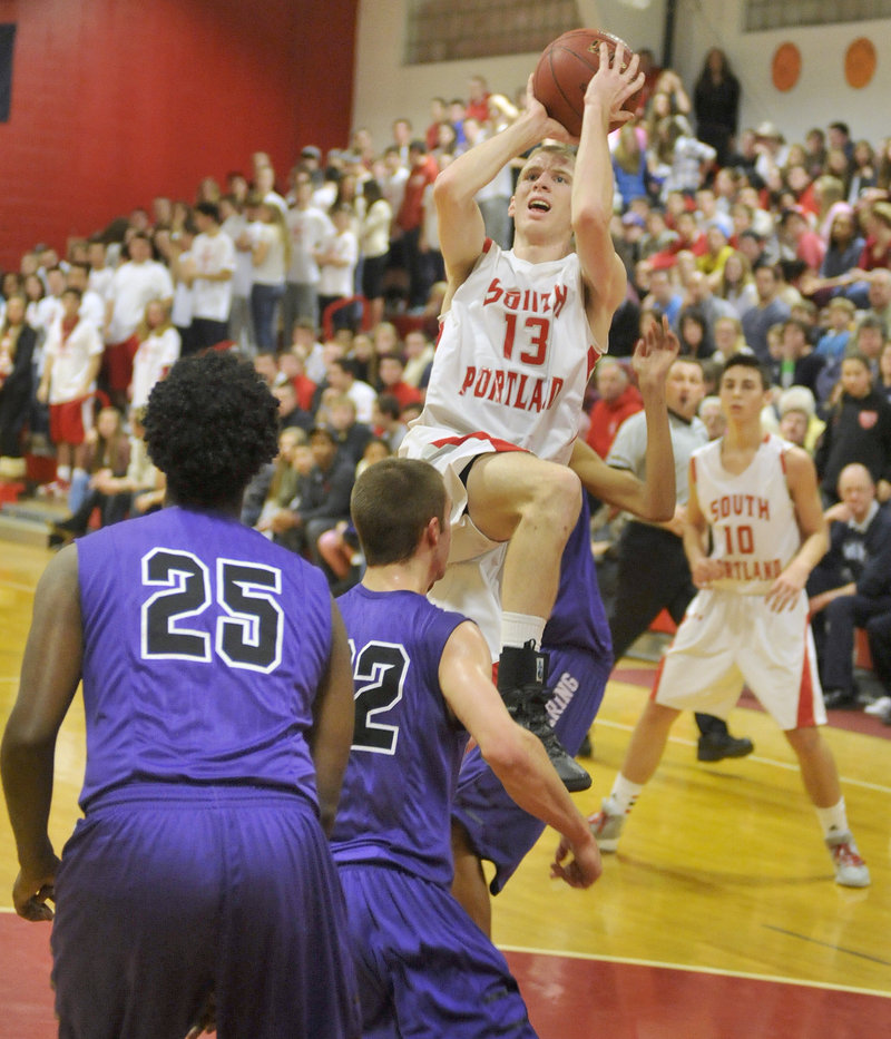 Tanner Hyland of South Portland finds room in the Deering defense to get off a shot Friday night. Hyland led the Red Riots with 15 points but the Rams came away with a 58-52 victory in overtime.