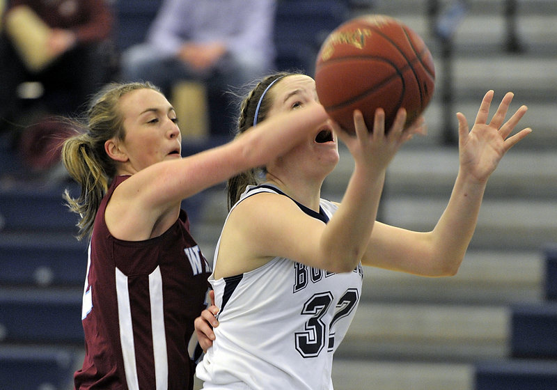 Sam Frost of Windham, left, knocks the ball from Brianna Holdren of Portland, who was attempting to score on a fast-break layup Saturday during their SMAA schoolgirl basketball game at the Portland Expo. Frost scored 12 points in Windham’s 55-43 victory.