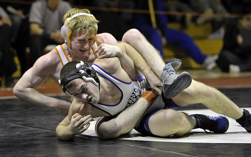 Jackson Howarth of Marshwood attempts to work out of a hold applied by Shane Jennings of Danbury, Conn., during the wrestling tournament in Sanford. Howarth reached the 145-pound final.