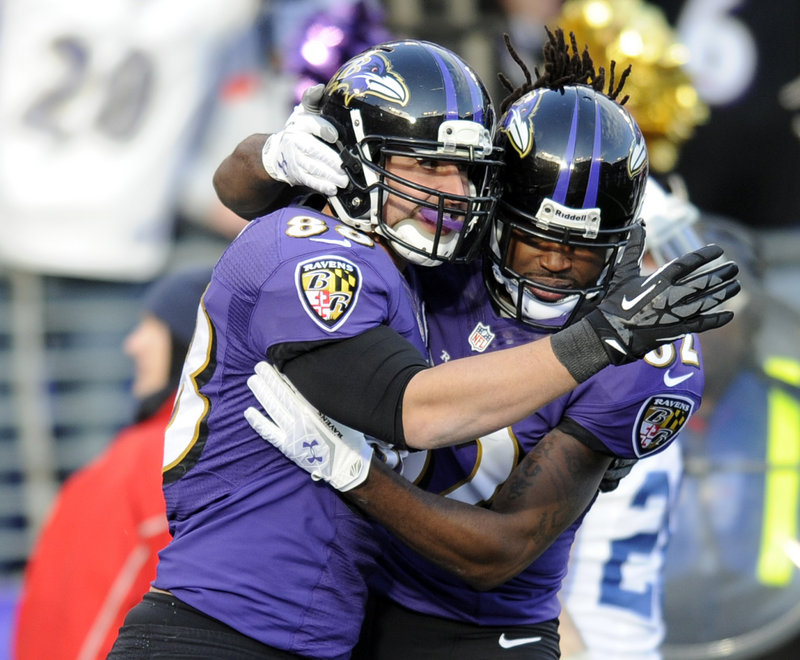 Dennis Pitta, left, celebrates with Torrey Smith after catching a touchdown pass that helped Baltimore earn a 24-9 victory over the Colts.