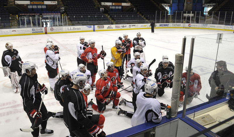 The Portland Pirates gather around Coach Ray Edwards during Monday’s practice at the Cumberland County Civic Center. The Pirates could be losing as many as four players to the parent Phoenix Coyotes with the NHL labor dispute settled.