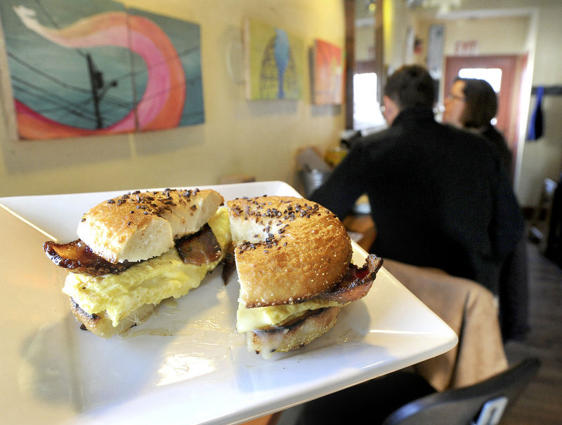 A bacon, egg and cheese bagel sandwich makes its way to a customer at 158 Picket Street Cafe.