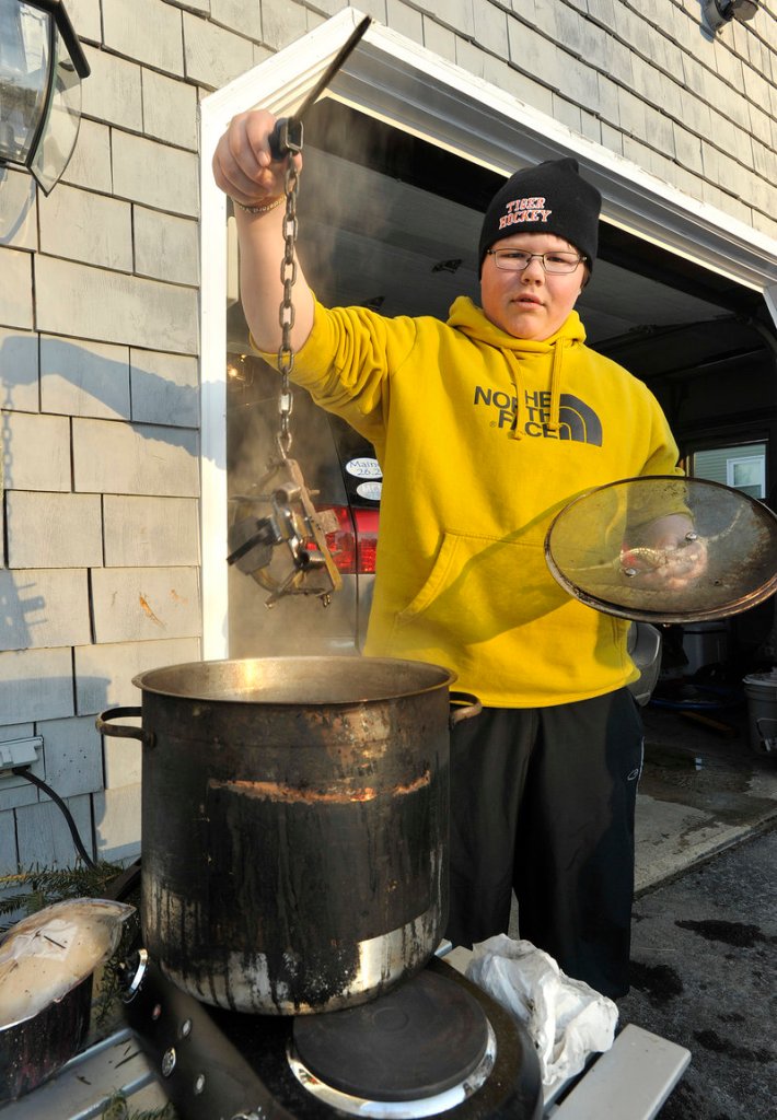 Thomas Behen, 14, has seen coyotes in his Biddeford neighborhood on several occasions this winter. Behen is de-scenting an animal trap that he hopes to use to trap coyotes near his home once he passes a trapping course and receives his trapping license.