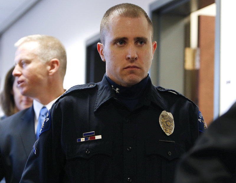 Aurora Police Officer Justin Grizzle leaves court after testifying at a preliminary hearing for James Holmes at the courthouse in Centennial, Colo., on Monday.