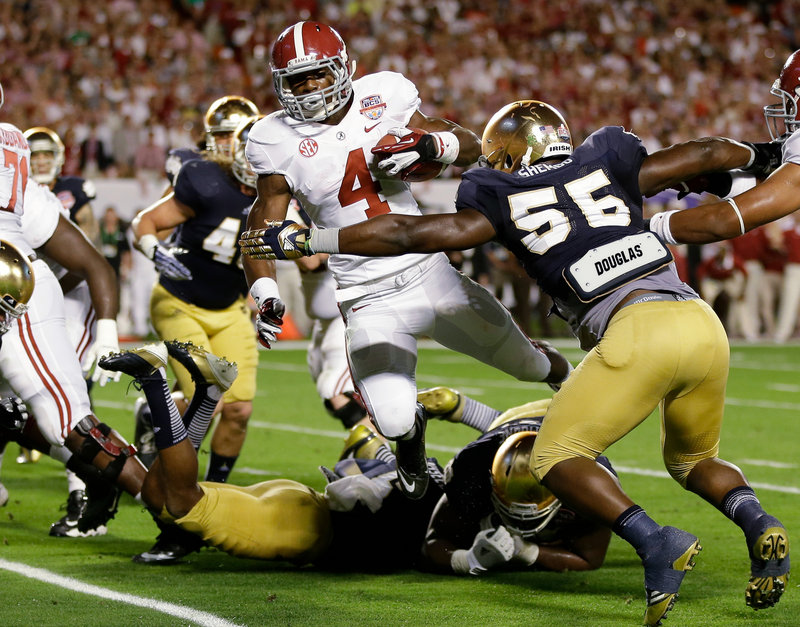 T.J. Yeldon of Alabama runs through the Notre Dame defense. Yeldon ran 21 times for 108 yards and one touchdown in the 42-14 win.