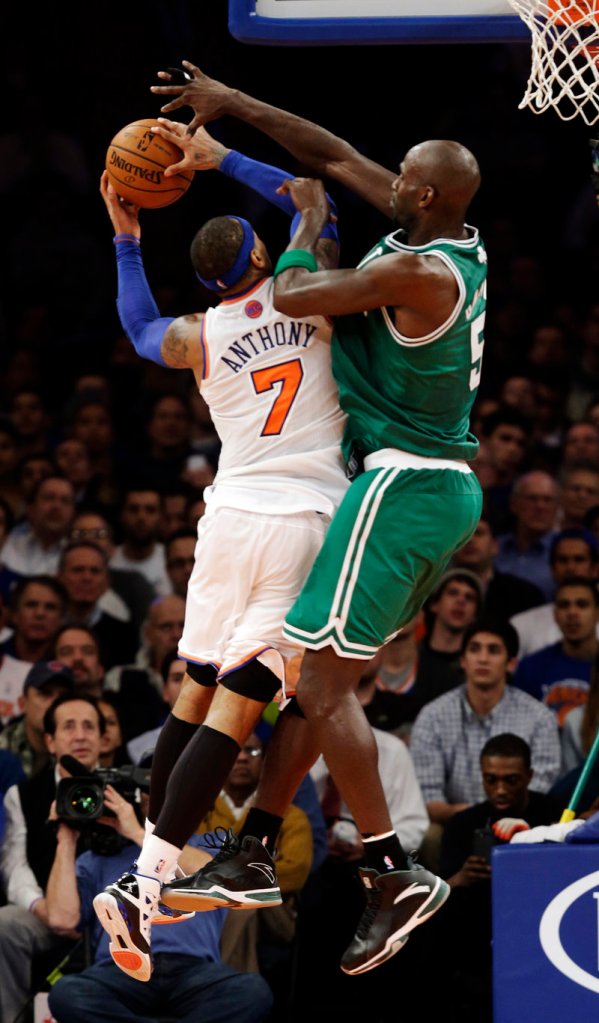 Boston’s Kevin Garnett, right, goes up strong against New York’s Carmelo Anthony as the Celtics held the Knicks to 40 second-half points in a 102-96 win on Monday.