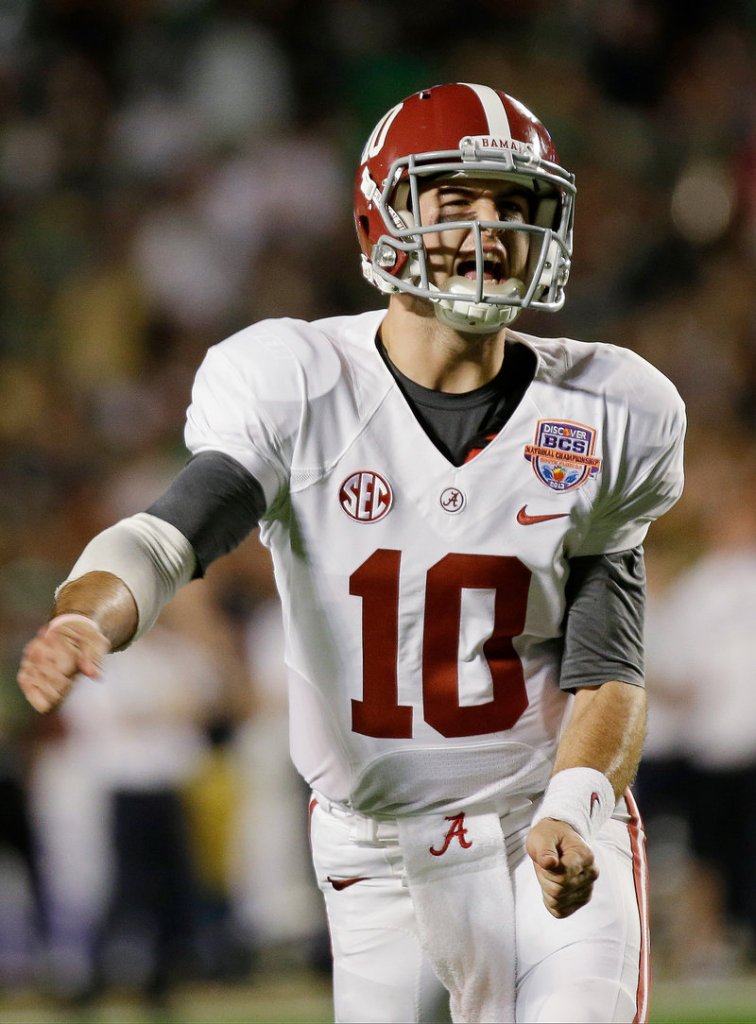 It’s time to celebrate for Alabama quarterback AJ McCarron, who threw four touchdown passes Monday night against Notre Dame in a 42-14 win in the BCS championship game at Miami.