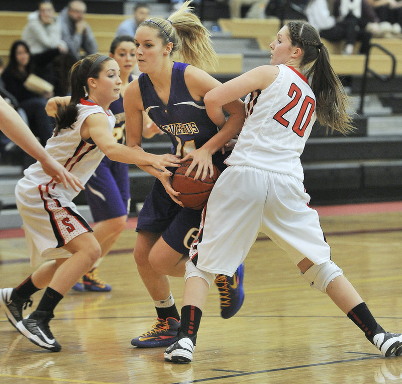 Brooke Flaherty, who scored 23 points for Cheverus, is fouled while driving between Taylor LeBorgne, left, and Ashley Briggs of Scarborough.