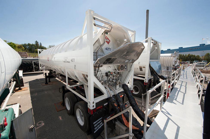 Tanker trailers filled with liquefied natural gas feed the Madison Paper Industries mill last fall. LNG is replacing 8 million gallons of oil a year at the mill, and saving the company millions of dollars.