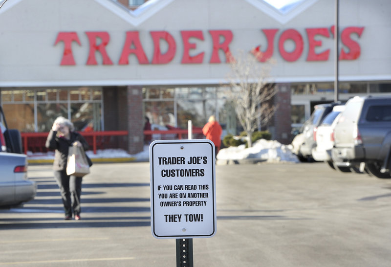 A sign warns Trader Joe's customers against parking in West Marine's lot along Marginal Way in Portland.