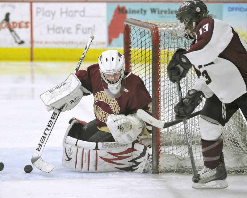 Thornton Academy goalie Andrew Huot makes a save as Gorham’s Alex Lambert looks for a rebound Thursday at USM Ice Arena. Huot stopped 28 shots in a 7-4 win.