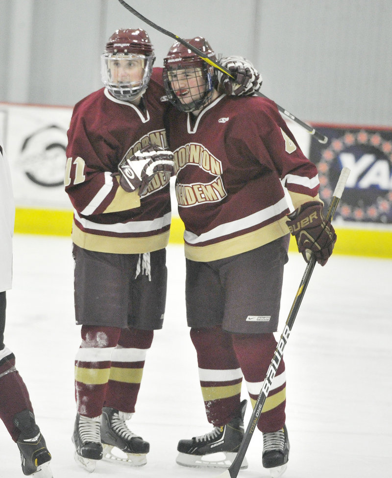 Owen Elliott, right, celebrates with Justin Cloutier after scoring a goal in the first period. Cloutier later added an empty-net goal to clinch the victory.