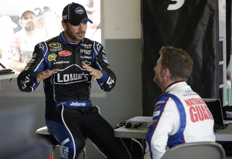 NASCAR driver Jimmie Johnson, left, and Dale Earnhardt Jr. take a break in the garage during auto testing Thursday at Daytona International Sppedway in Florida.
