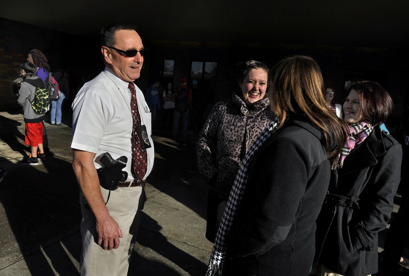 Retired Pennsylvania state trooper Les Strawbridge chats with Butler Intermediate High School teachers. The school system hired enough retired troopers to put one in each school.