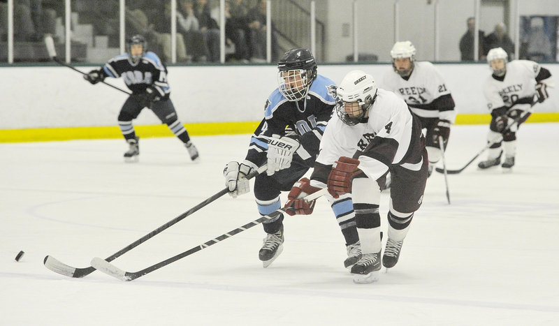 Miles Shields, right, of Greely and Derek Neal of York chase after the puck during Greely’s 13-0 victory Thursday night at Family Ice Center.