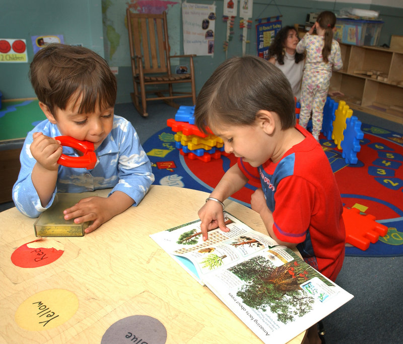 Children share a book at Head Start on Cumberland Avenue in Portland in 2003. Head Start was one of the programs that experienced funding cuts when last spring’s state budget was passed. This hit Maine women hard, since they are more likely than men to be single or custodial parents, say the heads of two nonprofits.