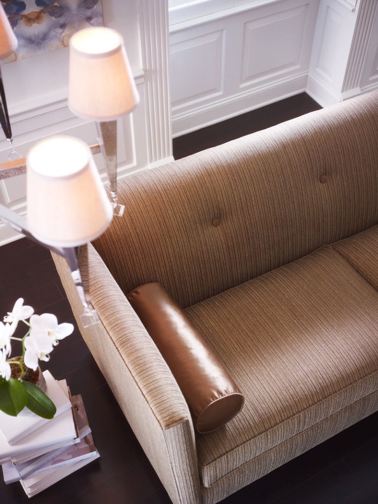 A Muse sofa from the Candice Olson collection boasts an elegant sheen, which is further enhanced by a silk accent pillow. The luminous look sashayed off the fashion runway and into the home.