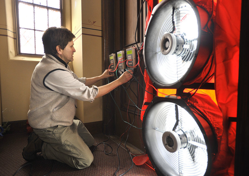 Energy consultant DeWitt Kimball operates large fans used to de-pressure the interior of the church as determine how much air is leaking from the building on Friday, January 11, 2013.