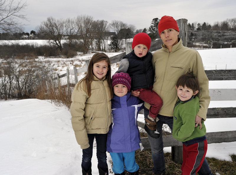 Sarah Russell poses Friday with her children, from left, Olivia, 9; Annie, 7; George, 3; and Charles, 5, in Cumberland. Russell supports hunting and gun ownership rights and allows hunting on her property, but she also believes in tighter restrictions on assault weapons and high-capacity magazines.