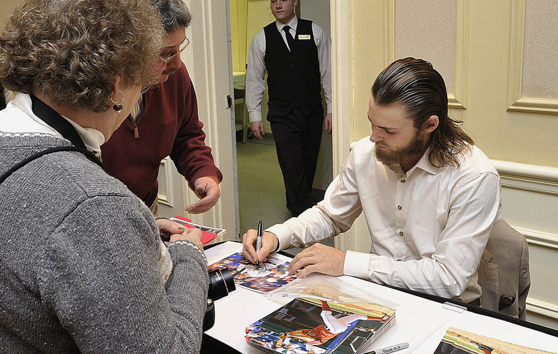 Josh Reddick, who hit 32 home runs last season for the Oakland Athletics, signs a photo Friday night at the Sea Dogs’ annual banquet, Reddick played for Portland in the 2008 and 2009 seasons.
