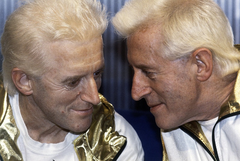 Jimmy Savile, right, who died last year at age 84, poses with a wax model of himself at Madame Tussauds museum in London in 1986. A police investigation has revealed how he used his celebrity status to prey on young, vulnerable people – including those at schools and hospitals.