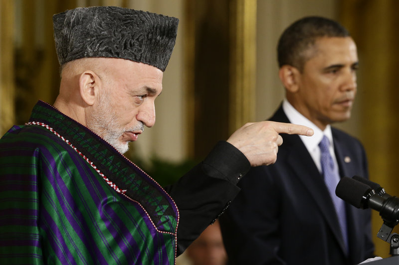 Afghan President Hamid Karzai takes questions from reporters during his joint news conference with President Barack Obama at the White House.