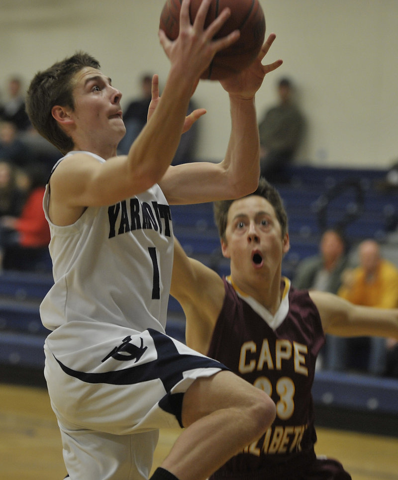 David Murphy, who led Yarmouth with 16 points, drives to the basket against Xander Schonewolf of Cape Elizabeth.