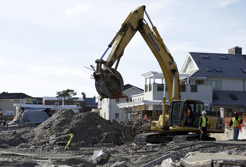 The remains of a house damaged by Superstorm Sandy and then bulldozed by a contractor are removed from the beach in the Belle Harbor section of the Rockaways on Thursday.