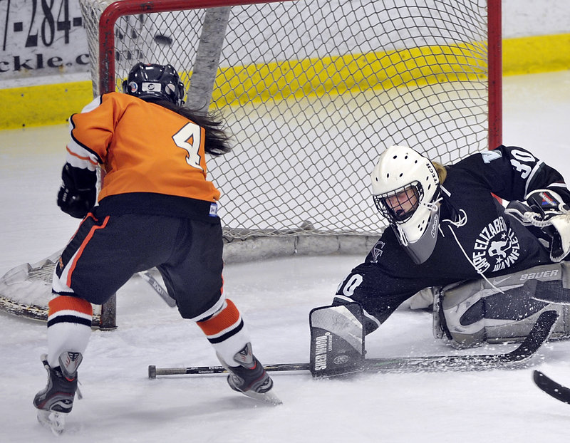 Katherine Dumoulin of Biddeford fires the puck into the net Saturday as Cape Elizabeth/Waynflete goalie Lily Jordan attempts to make the save. Biddeford improved to 6-6 with a 6-0 victory.