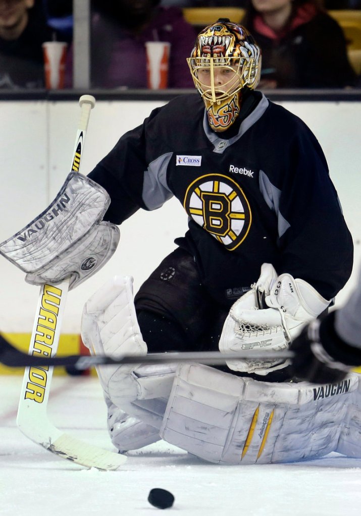 Bruins goaltender Tuukka Rask keeps his eye on the puck during practice at the TD Garden on Sunday as Boston opened its abbreviated training camp.