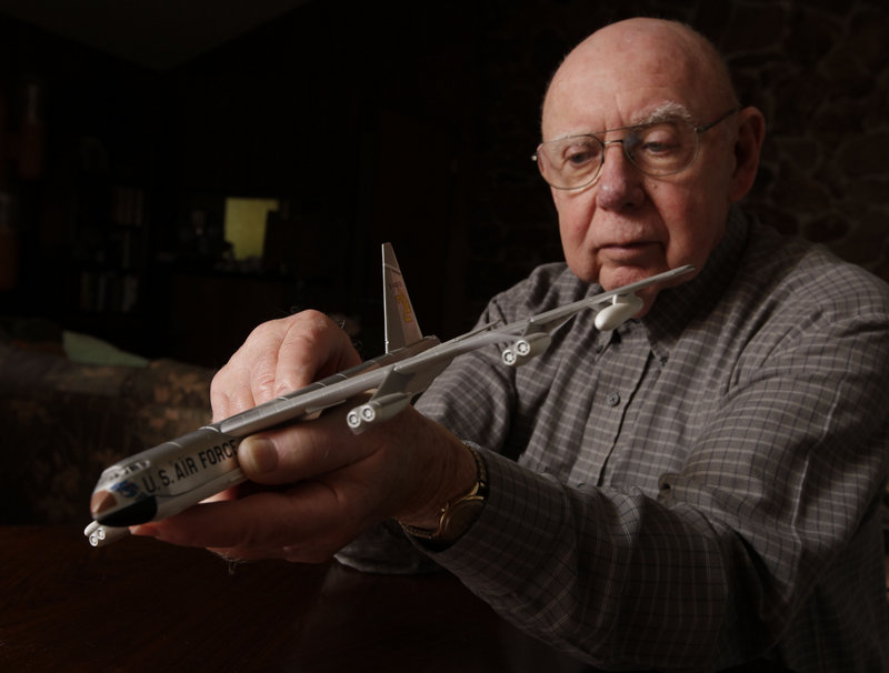 Gerald Adler, the navigator of a B-52 that crashed in remote Maine woods in 1963, holds a model of the legendary bomber at his home in Davis, Calif.