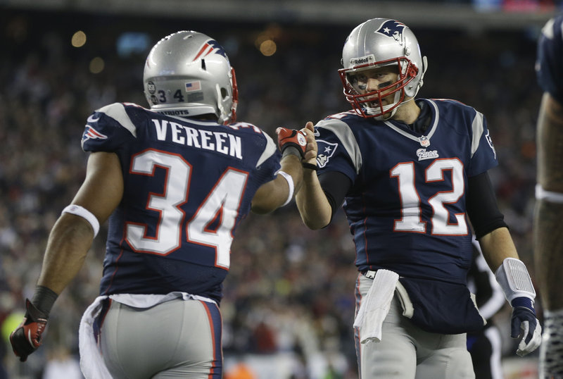 Shane Vereen is congratulated by Tom Brady after the first of his three touchdowns against the Texans. The backup running back caught two TD passes and rushed for a score.