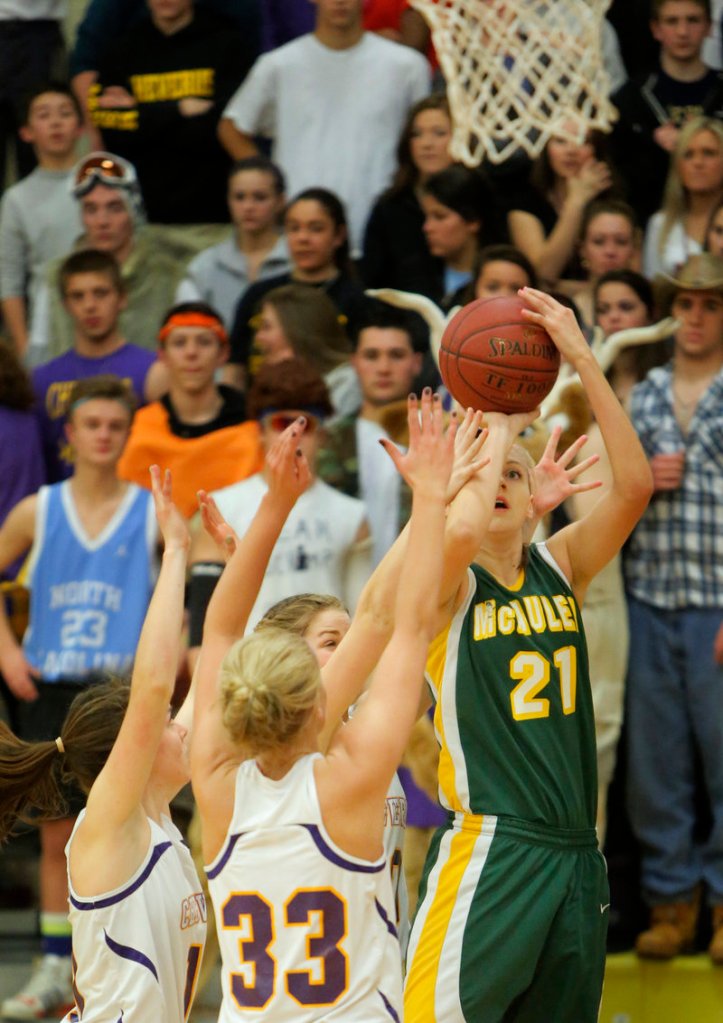 Olivia Smith, who played a strong post game Tuesday night for McAuley, takes a step outside to loft a jumper over the Cheverus defense, including Kylie Libby, 33, during a 51-30 victory.