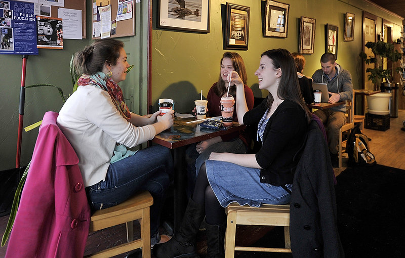 From left, junior Karianna Merrill, freshman Allie Macisso and sophomore Brittany Getch, regulars at the Gorham Grind coffee shop, relax after classes at USM-Gorham. Gorham shops would like to attract a before-class crowd, too.