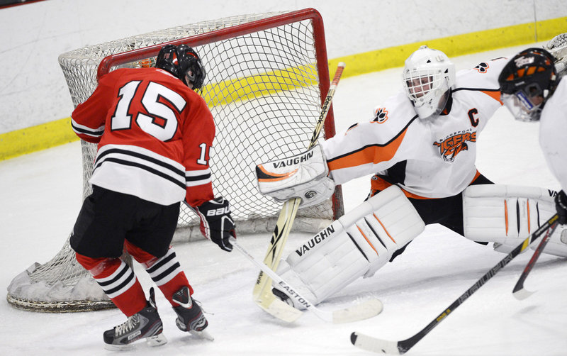 Biddeford goalie Jon Fields, who finished with 25 saves, stretches to deny a scoring bid, blocking a shot by Cam Brochu of Scarborough.