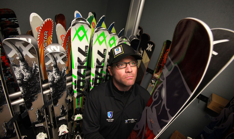 Squaw Valley ski demo shop manager Josh Holm pulls a pair of wide skis off a rack at the shop in Truckee, Calif. In the same four-year period, sales of skis climbed 3 percent, while sales of snowboards and snowboard equipment slipped 21 percent.