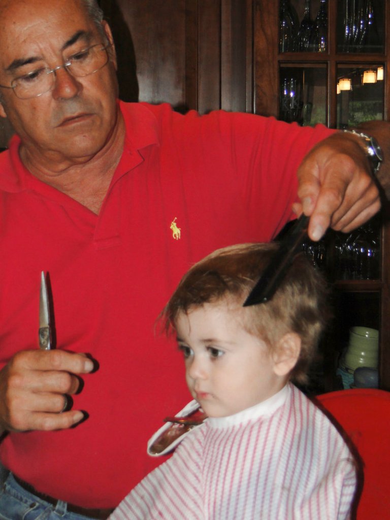 Jim Rogers cuts the hair of his grandson, Jason Kinsella in 2011.
