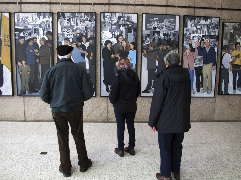 Richard and Pat Bamforth look at a mural depicting Maine’s labor history Jan. 14 at the Maine State Museum in Augusta. A reader wonders what has happened to make the mural – which was removed from a state office building in 2011 – suitable for public display once again.