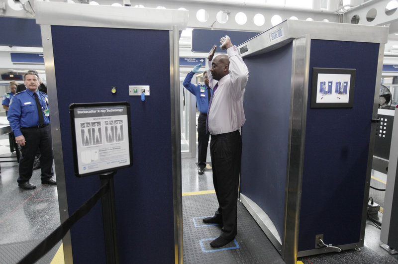 Volunteers pass through the first full body scanner installed at O’Hare International Airport in Chicago. The airport scanners with their all-too-revealing body images will soon be going away because the company that makes them can’t fix the privacy issues.