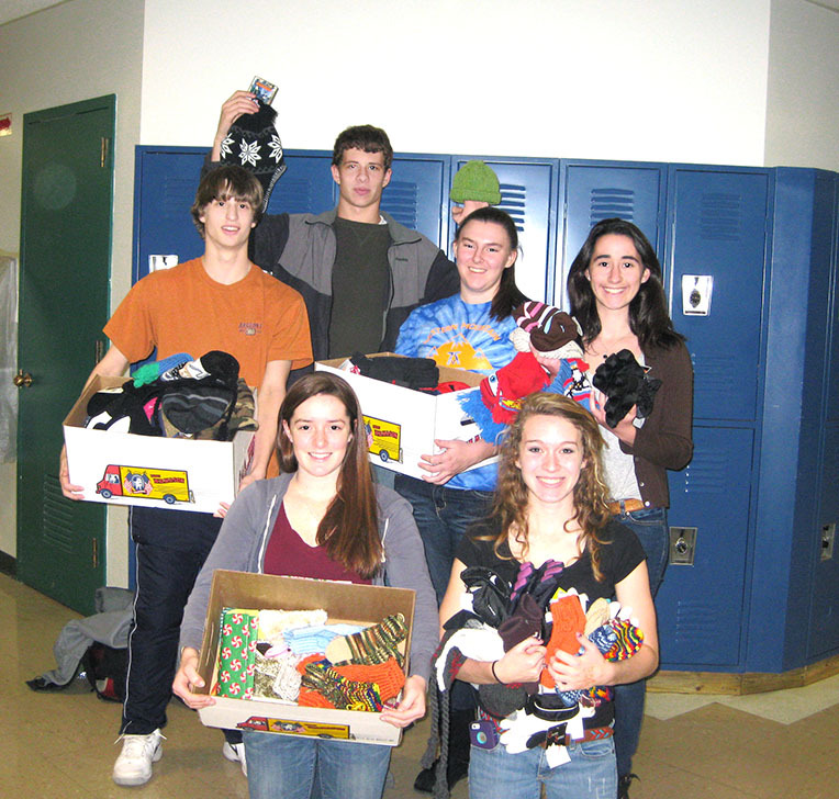 Bonny Eagle High School National Honor Society members, from left, rear, Connor Shields, Ian Smith, Marley Harmon and Gaelyn Lindauer, and from left, front, Natalie Hewitt and Samantha Cox show off hats, mittens and gloves the group purchased to benefit Greater Portland area foster children from Woodfords Foster Services.