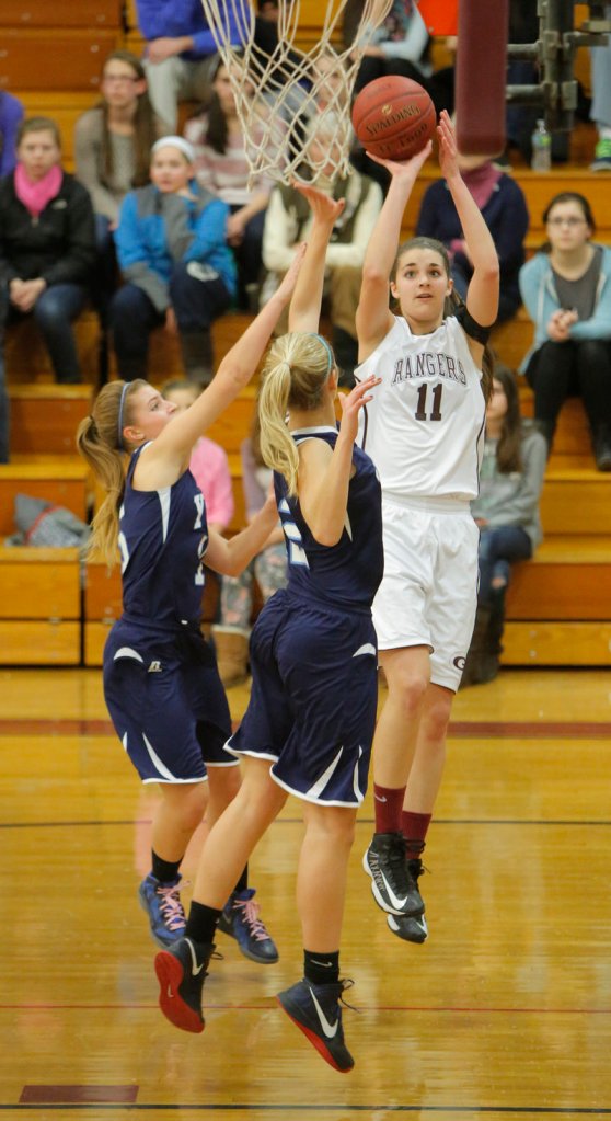 Ashley Storey of Greely shoots over York’s Anne Graziano, left, and Emily Campbell. Storey scored 14 points, but Campbell had 16 points and 11 rebounds to help lead the Wildcats to a 62-39 victory.
